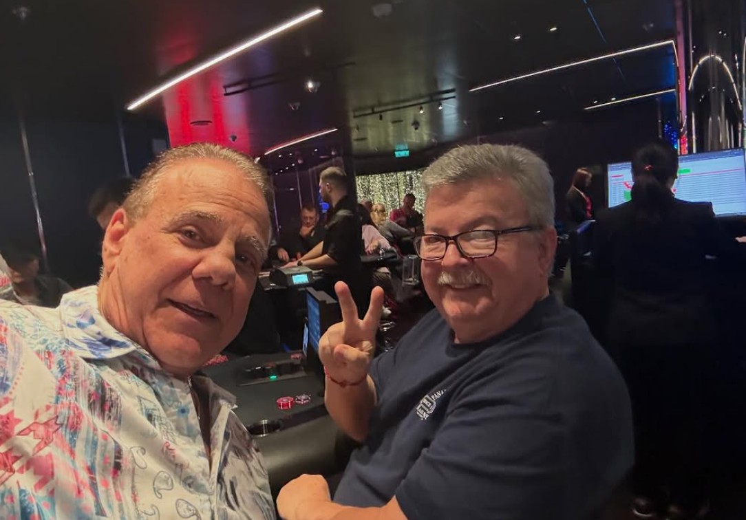 Two guests smiling at a casino table